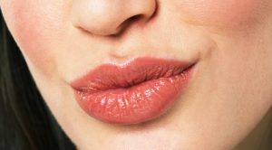 Young woman puckering lips, close-up